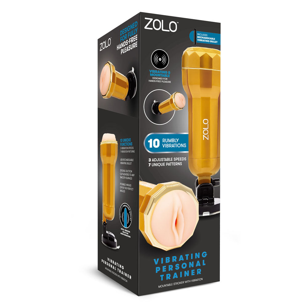 The image presents the packaging of the Zolo Vibrating Personal Trainer - USB Rechargeable Vibrating Vagina Stroker. The black box with blue and white text displays images of the gold product and highlights features like a realistic textured canal, 10 vibrations, 3 speeds, 7 patterns, and hands-free suction mount.