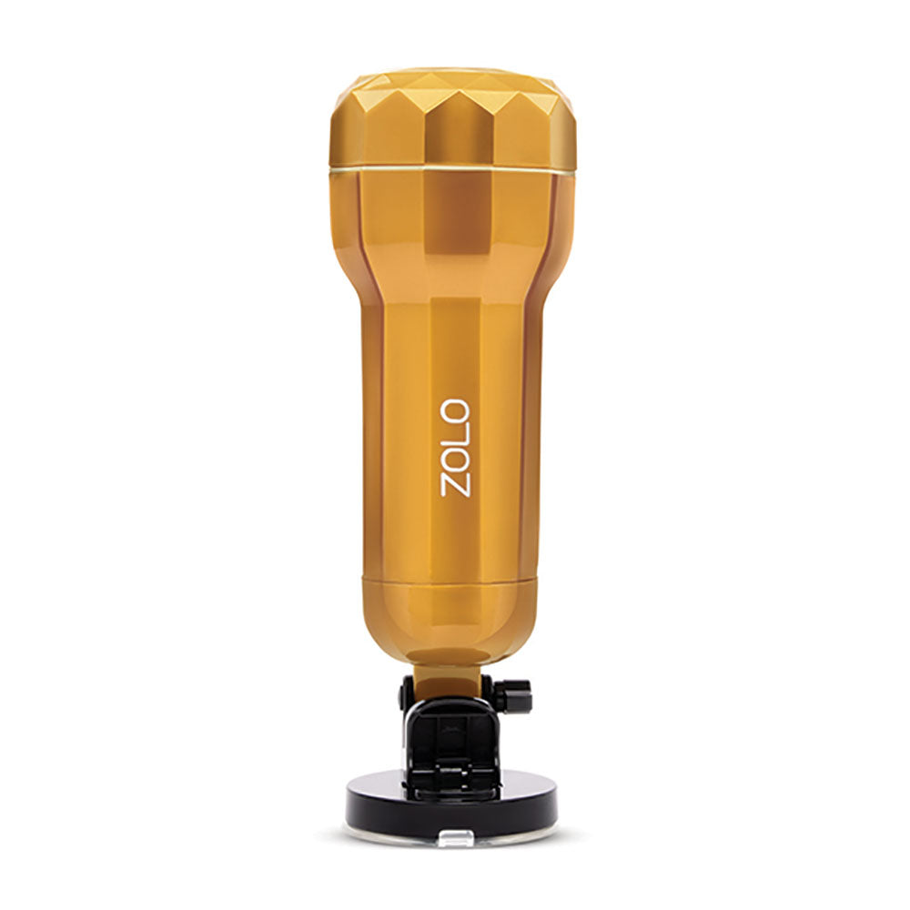 The Zolo Vibrating Personal Trainer is a gold, trophy-like cylindrical stroker featuring a geometric texture and adjustable suction cup for hands-free use. The word ZOLO appears in white on the side, and it includes a realistic textured canal inside. USB rechargeable, its perfect for solo sessions.