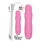 The Adam & Eve Diamond Darling is a pink silicone vibrator with a smooth, contoured design featuring velvety silicone and a round tip. It has clear circular gems at the base and comes in packaging highlighting its powerful speeds along with the Adam & Eve logo.