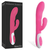 The Adam & Eve The Warming Rabbit G - Pink features dual stimulation with a G-Spot tip and enticing arms. Its velvety surface transitions to a white base with control buttons. The box mirrors the product image and branding, perfectly matching its design.