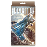 The Alien Nation - Gila - Blue/Gold 14 cm Penis Sheath packaging features a textured, body-safe silicone sheath resembling an alien, adorned with space-themed graphics and promising to be the Ultimate Fantasy for Apocalecstasy enthusiasts.