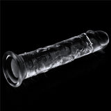 A transparent Flawless Clear Dildo 7 from the LOVETOY Shameless Clear Series sits on a black background. Its swirling, textured pattern in varying shades complements the smooth, polished finish. One end is rounded while the other is open with a rim, designed as a skin-safe transparent toy.