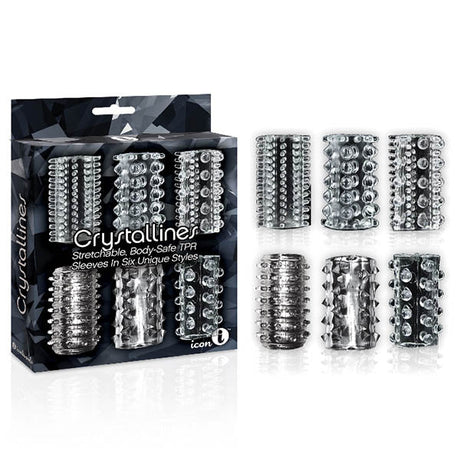 The 9s Crystalline TPR Cock Sleeves set includes six transparent, stretchable sleeves, each showcasing unique textures like spikes, ridges, and studs for enhanced sensations. The box features a dark geometric design.